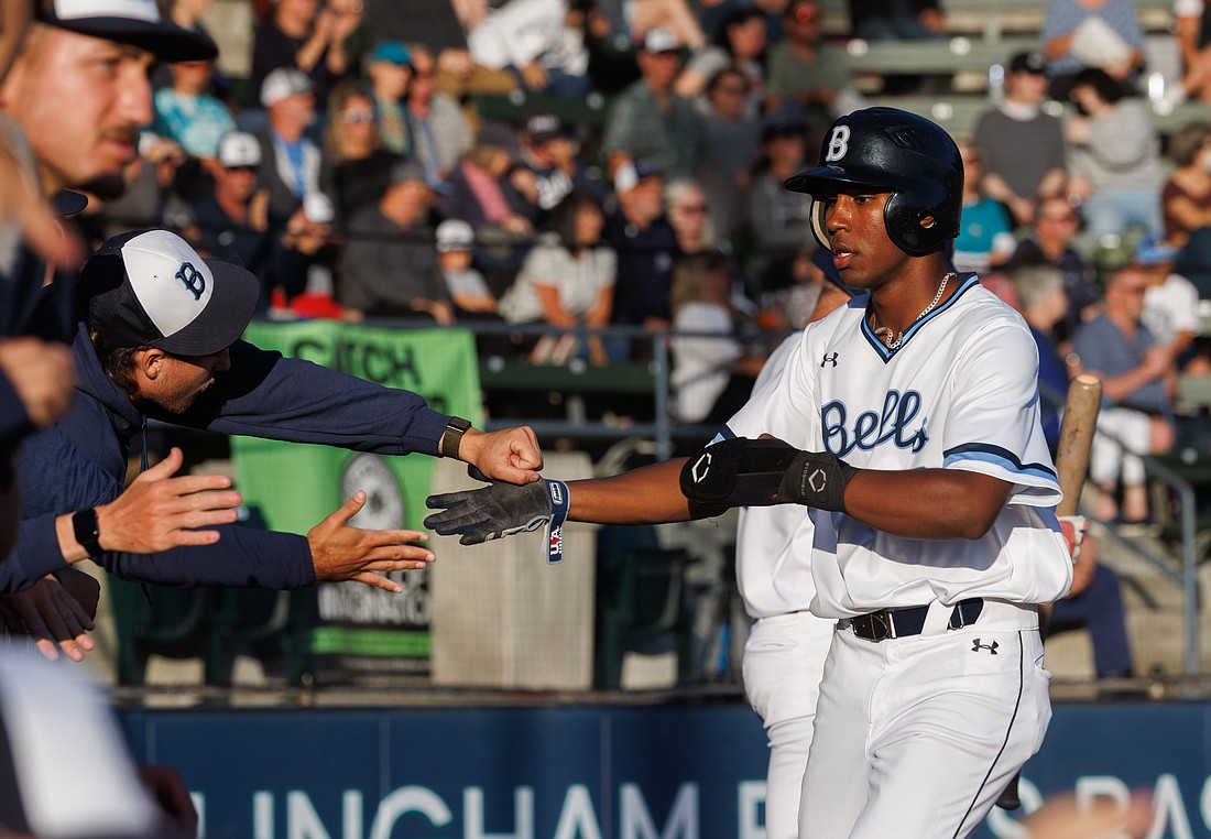Touissaint Bythewood gets a fist bump after scoring a run as the Bellingham Bells beat the Victoria HarbourCats 8-3 on Aug. 4.
