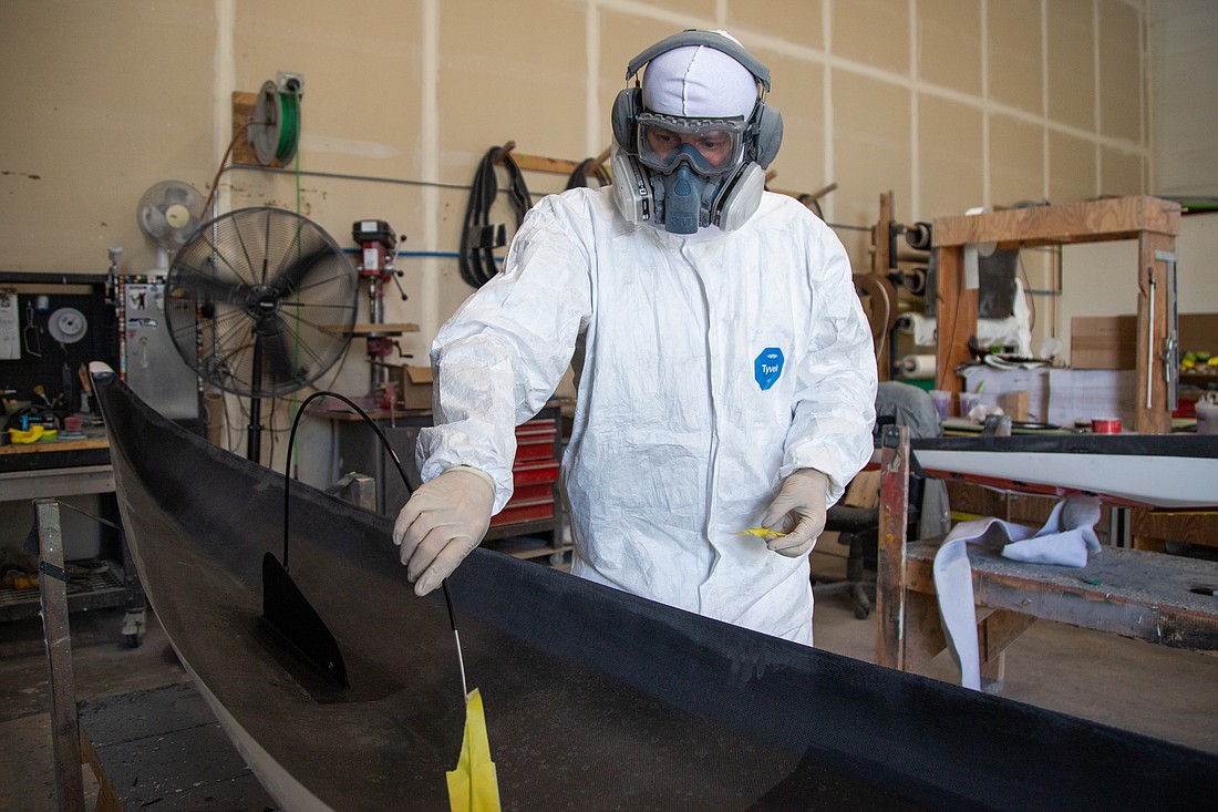 Ryan Paul builds a composite sea kayak at Sterling Kayaks in Bellingham on July 21. The business makes its kayaks locally and ships internationally.