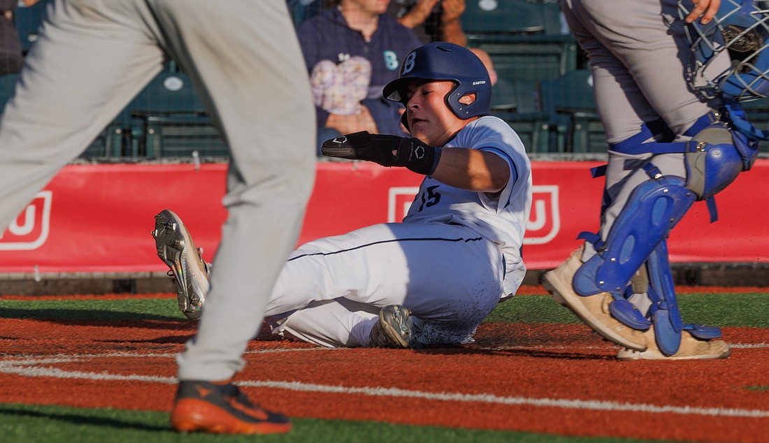Jaidon Mathews slides in for the run as the Bellingham Bells beat the Victoria HarbourCats 8-3 on Aug. 4.