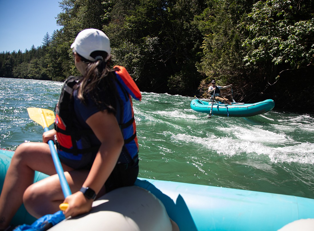 Hailey Palmer, left, watches Cascadia Rafting guide Nick Allen pull his boat through rapids with oars on the Skagit River on Aug. 8. Each rafting trip requires two boats to travel together and lasts 2 to 3 hours.