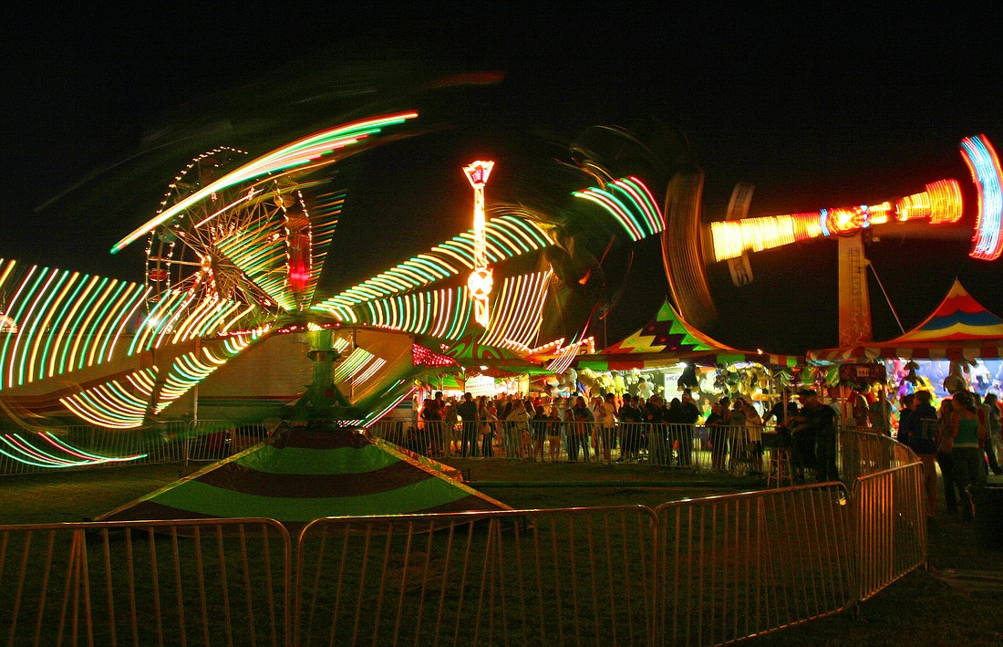 The midway at the Northwest Washington Fair in Lynden is a popular nighttime gathering spot for thrill-seeking carnival ride fans, not to mention that one non-spin-fan designated family member assigned to stand and hold everyone's stuffed animals.