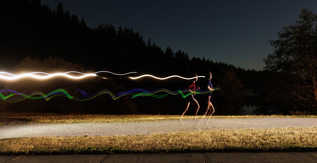 Lit by starlight and headlamps, Natalie Fuller, right, runs with a pacer runner in the Hamster Endurance Run at Lake Padden on Aug. 13. Runners could choose from a six-, 12-, 24- or 32-hour race loop starting Aug. 13 and ending the afternoon of Aug. 14.