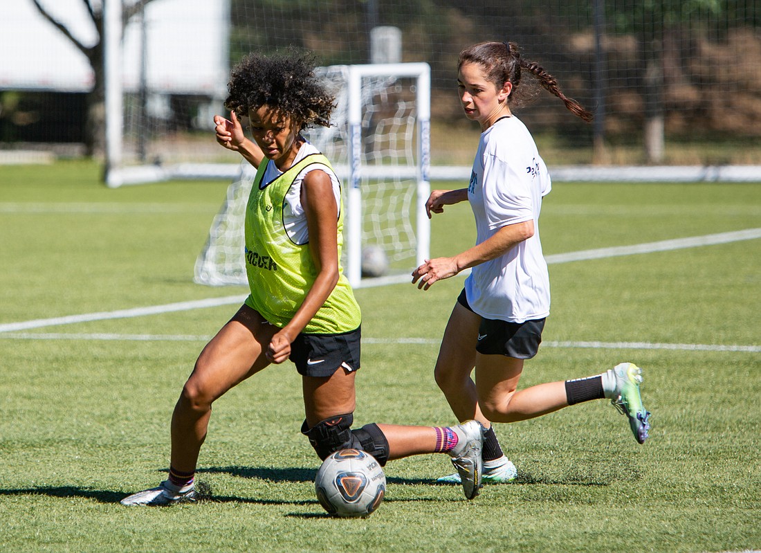 Western women's soccer midfielder Payton Neal, left, dribbles the ball before passing to a teammate during practice at Harrington Field on Aug. 15.