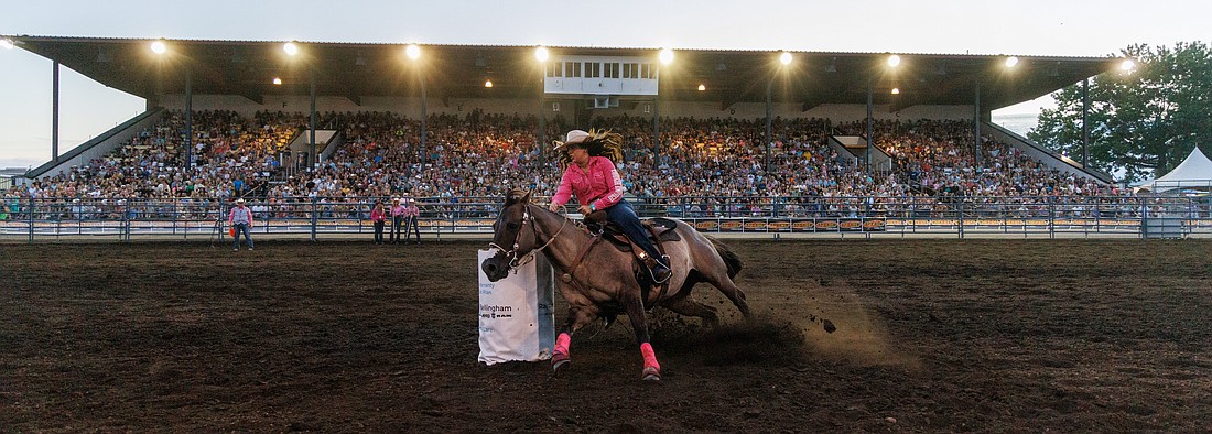 Aimee Henderson of Everson turns around a barrel during the Barrel Racing event of the Lynden PRCA Rodeo on Aug. 15. Henderson finished with a time of 16.56.