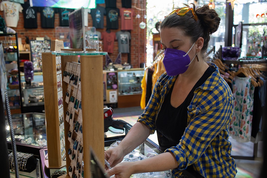 Manager Erika Millage tags and organizes earrings at The Third Planet on Aug. 16. The store is one of more than two dozen businesses taking part in the revitalized Downtown Bellingham Insiders program.