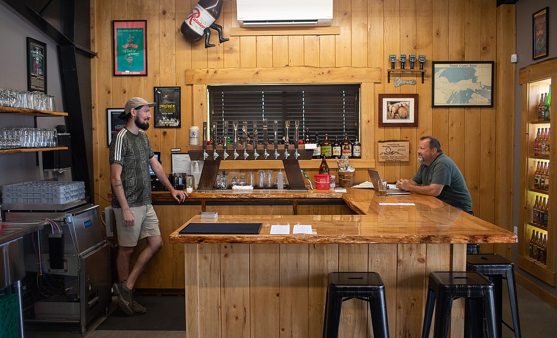 Andrew Nelson, left, and John Risser chat at the Barrel House and Beer Shrine — North Fork's newest Bellingham location — on Aug. 23.