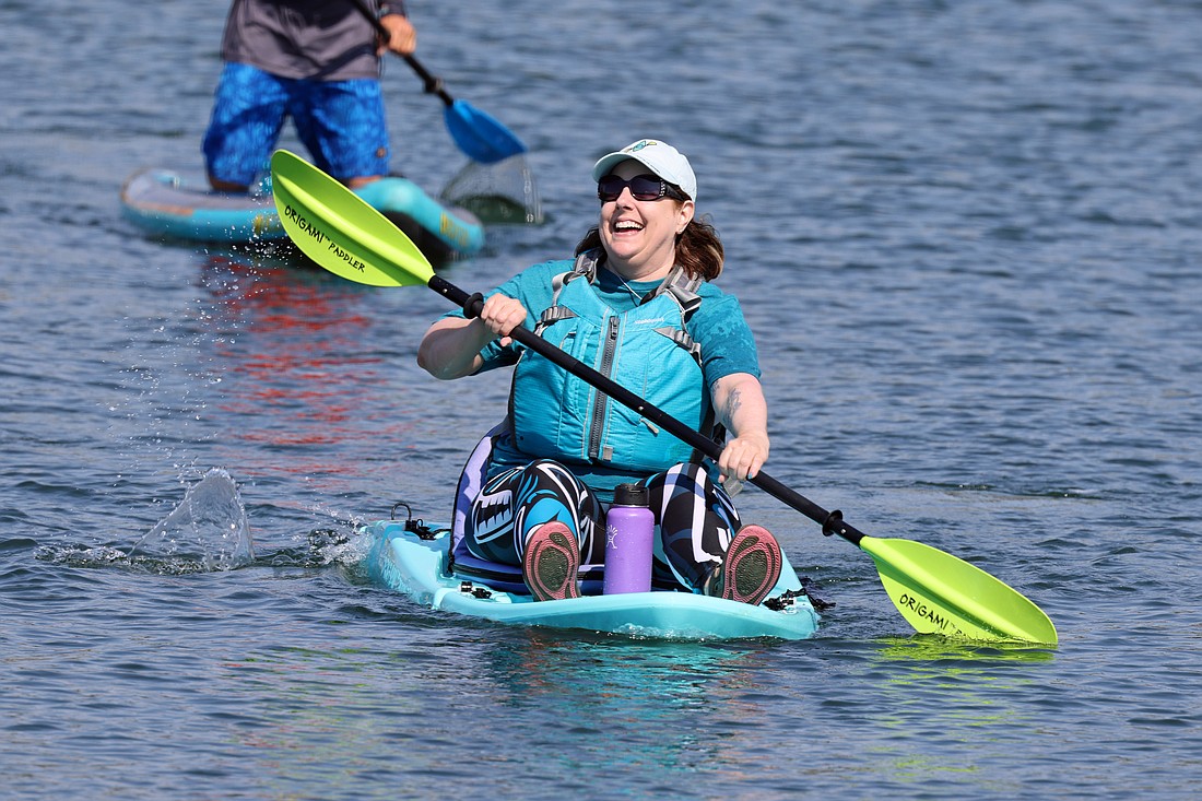 Kari Neumeyer of Bellingham beams as she nears the finish of an ovarian cancer fundraiser and awareness paddling event she organized Saturday on Bellingham Bay. The event drew about three dozen paddlers raising money and drawing attention to the deadly, difficult-to-diagnose disease.