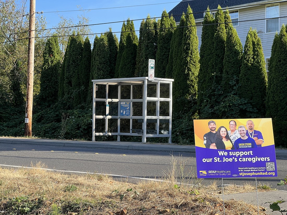 A sign supporting workers at PeaceHealth St. Joseph Medical Center stands near a bus stop on Donovan Avenue in Bellingham on Sept. 8. SEIU Healthcare 1199NW ratified a new contract with the hospital that includes a 7.5% raise for union members.