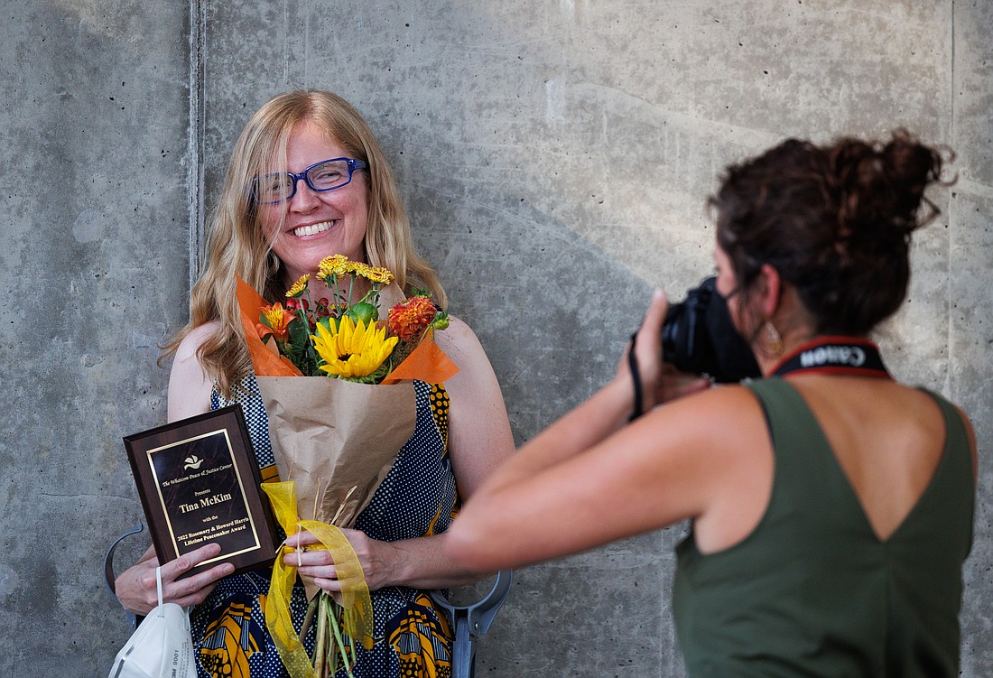 Tina McKim gets her photo taken after she was awarded the Lifetime Peacemaker Award from the Whatcom Peace & Justice Center at its 20th annual International Day of Peace celebration at the Depot Market Square on Sept. 11.