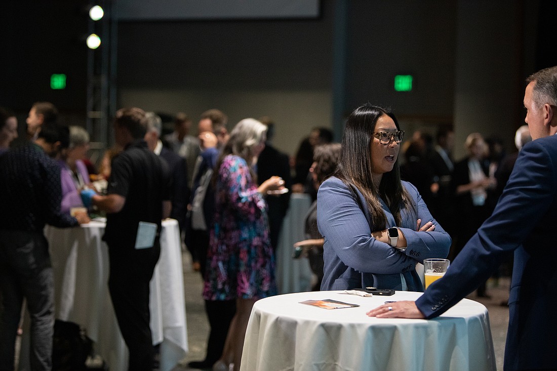Participants chat during a networking reception at the Cascadia 2050 Vision: Moving to Climate Action conference at Semiahmoo Resort on Sept. 12. A key part of the event was a new report highlighting public-private partnerships.