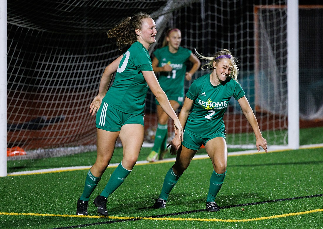 Sehome’s Caroline Law, left, heads for her teammates after scoring a goal as the Sehome girls’ soccer team beat Squalicum 3-0 on Sept. 15.