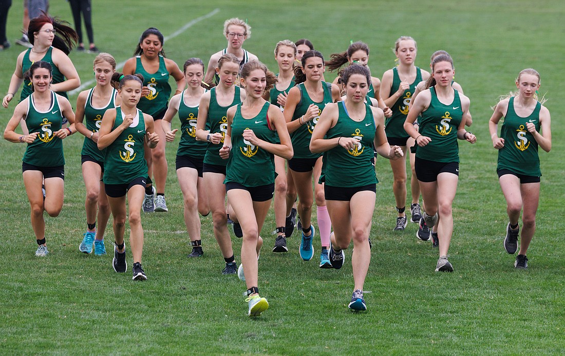 Kaia Szymczak and Evelyn Buetow, front-center, lead the Sehome girls cross country team at the start of a meet at Lynden High School on Sept. 14.