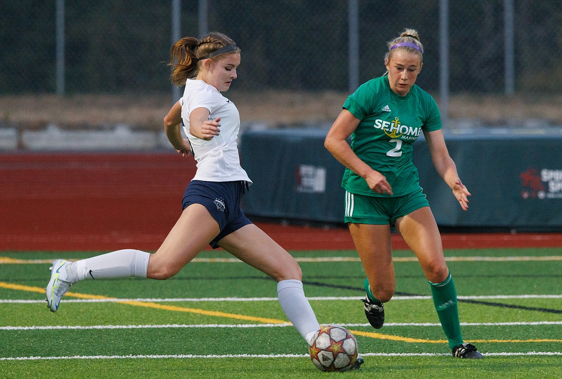 Squalicum's Elise Montgomery, left, takes a shot at the goal as Sehome's Evelyn Sherwood defends on the play on Sept. 15. Sehome beat Squalicum 3-0.