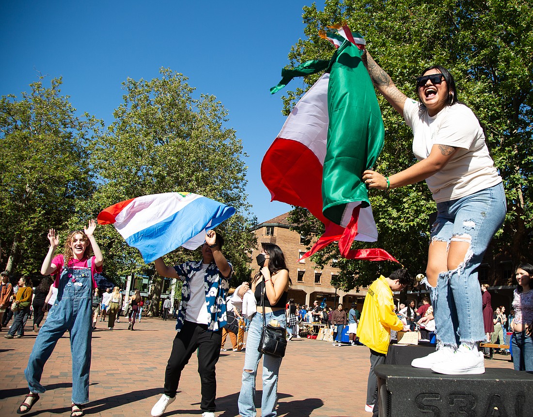 Yaileen Gonzalez with the Latinx Student Union waves a Mexican Flag and dances at the Associated Students Info Fair at Western Washington University on Sept. 19. Clubs and organizations from around campus gather at the start of each school year to invite new and returning students to their clubs.