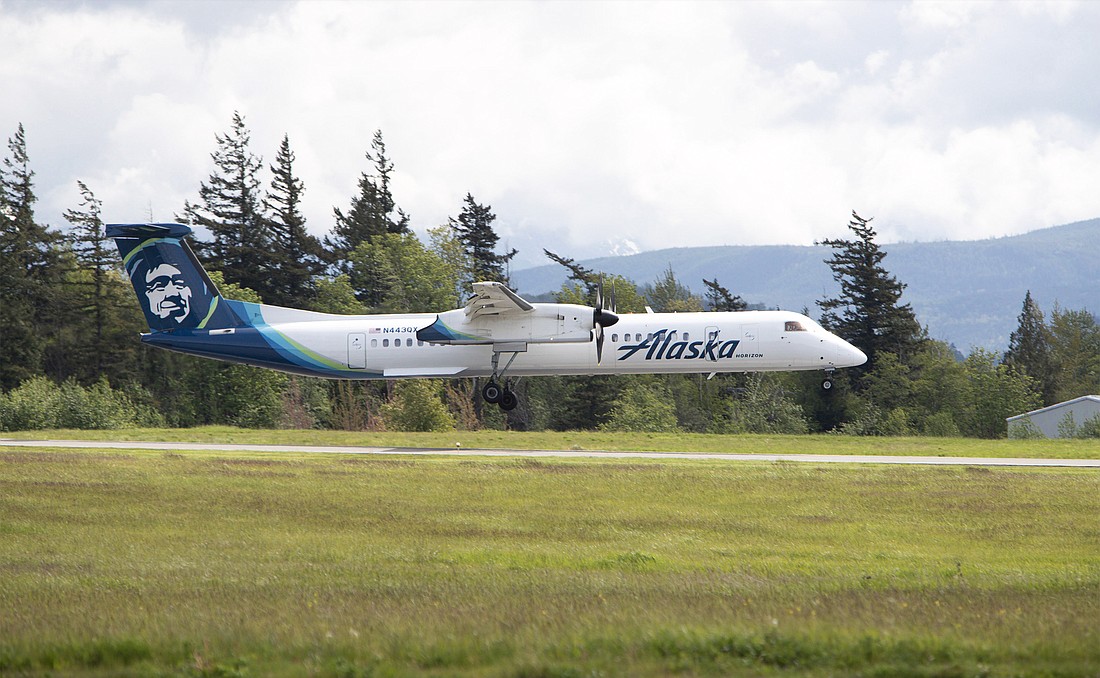 An Alaska Airlines flight lands at Bellingham International Airport in May. The airline will transition from Bombardier Q400 turboprop planes to Embraer 175 jets at the airport by the end of the year.
