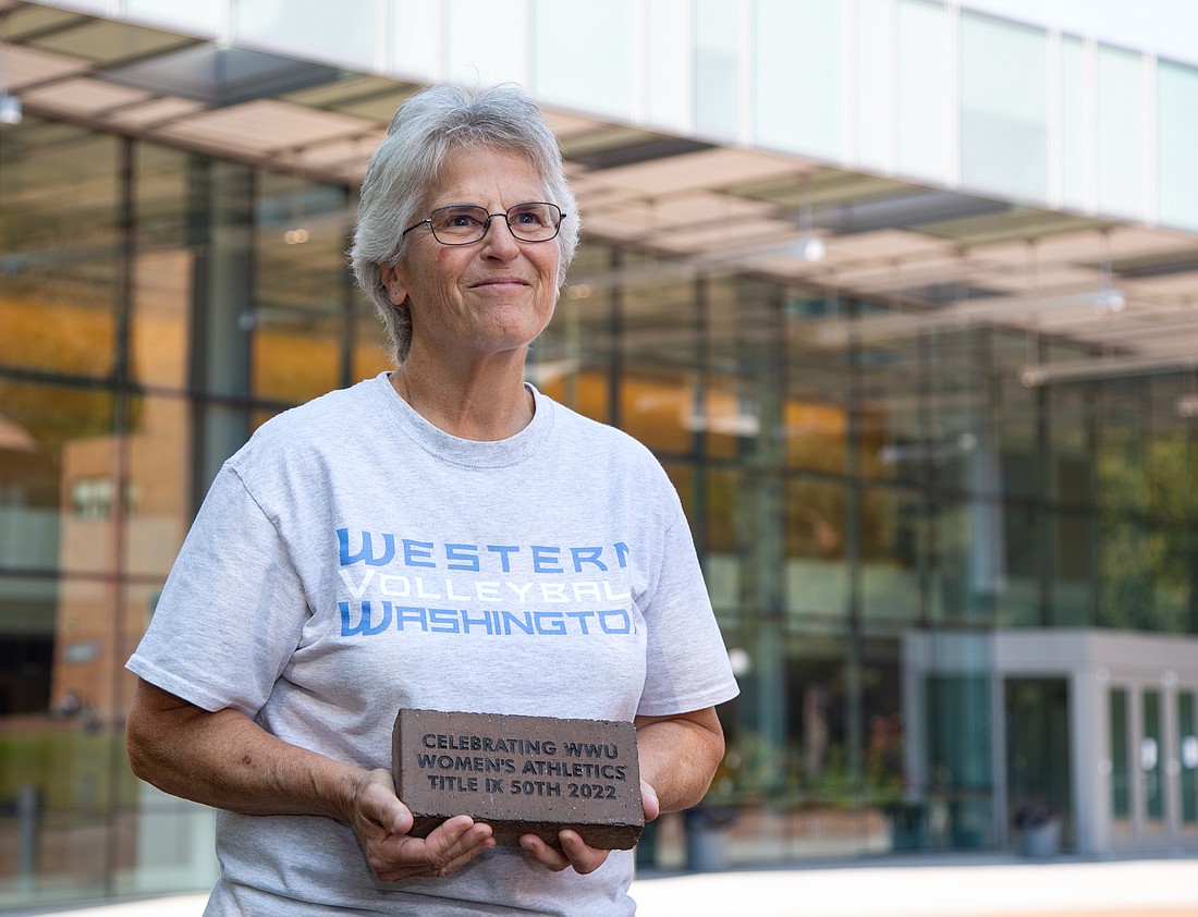 Terri McMahan holds a brick honoring Title IX outside of Carver Gym at Western Washington University on Sept. 26. McMahan played on Western's volleyball team in the 1970s and is in the university's athletics hall of fame.