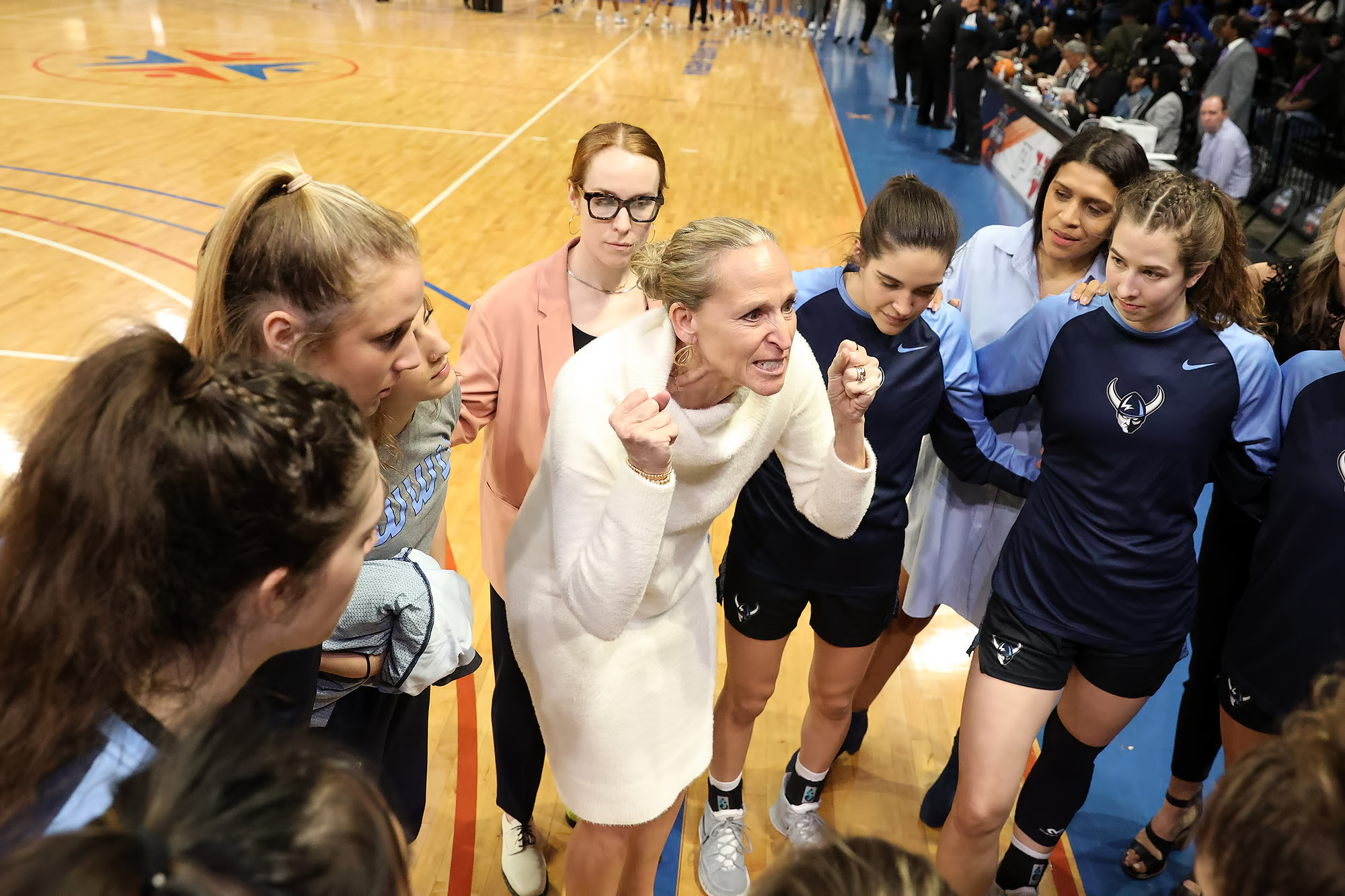 Part II: Western Washington University head coach Carmen Dolfo huddles with her basketball team before the NCAA Division II Elite 8 game against Glenville State on March 23.