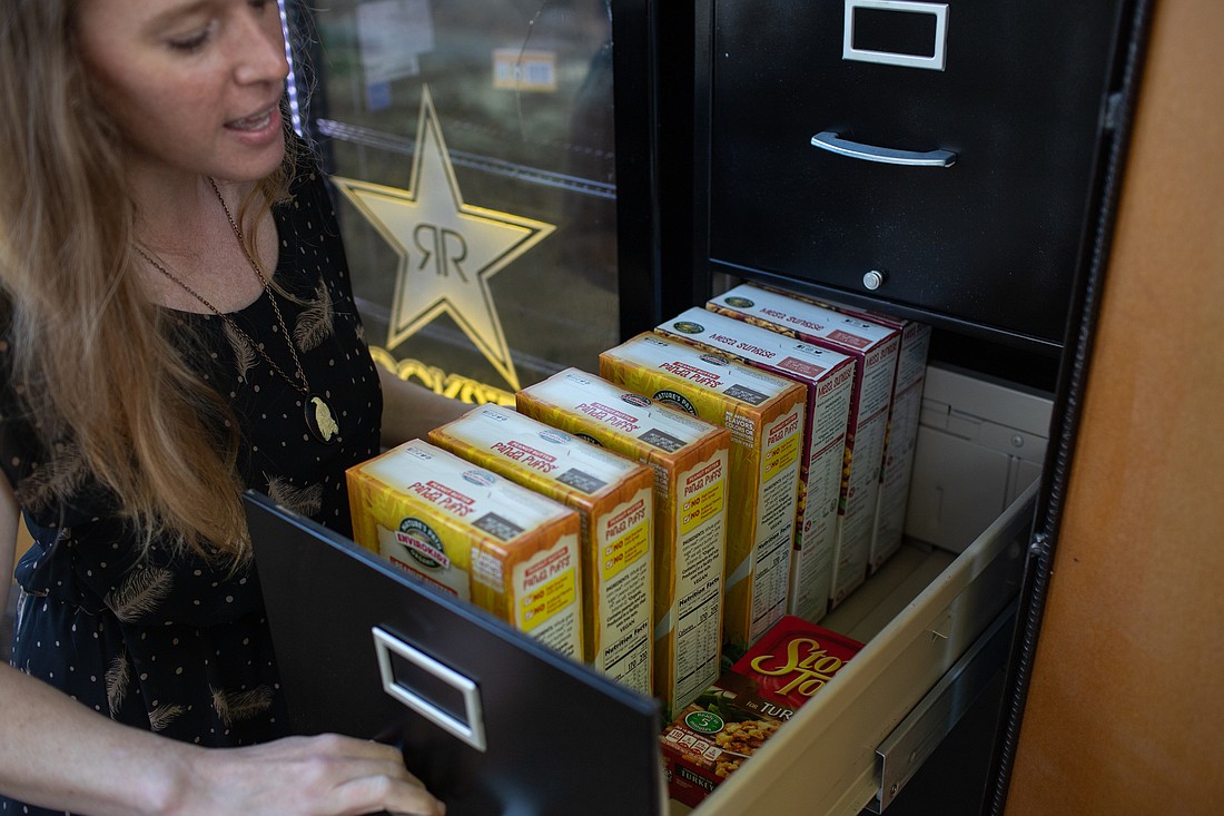 Brandi Hutton, the Toward Zero Waste program coordinator, pulls open a drawer of a converted filing cabinet filled with cereal at the new food pantry on Oct. 3. Sustainable Connections has placed the new "Freedge" behind and in partnership with The RE Store on Kulshan Street.