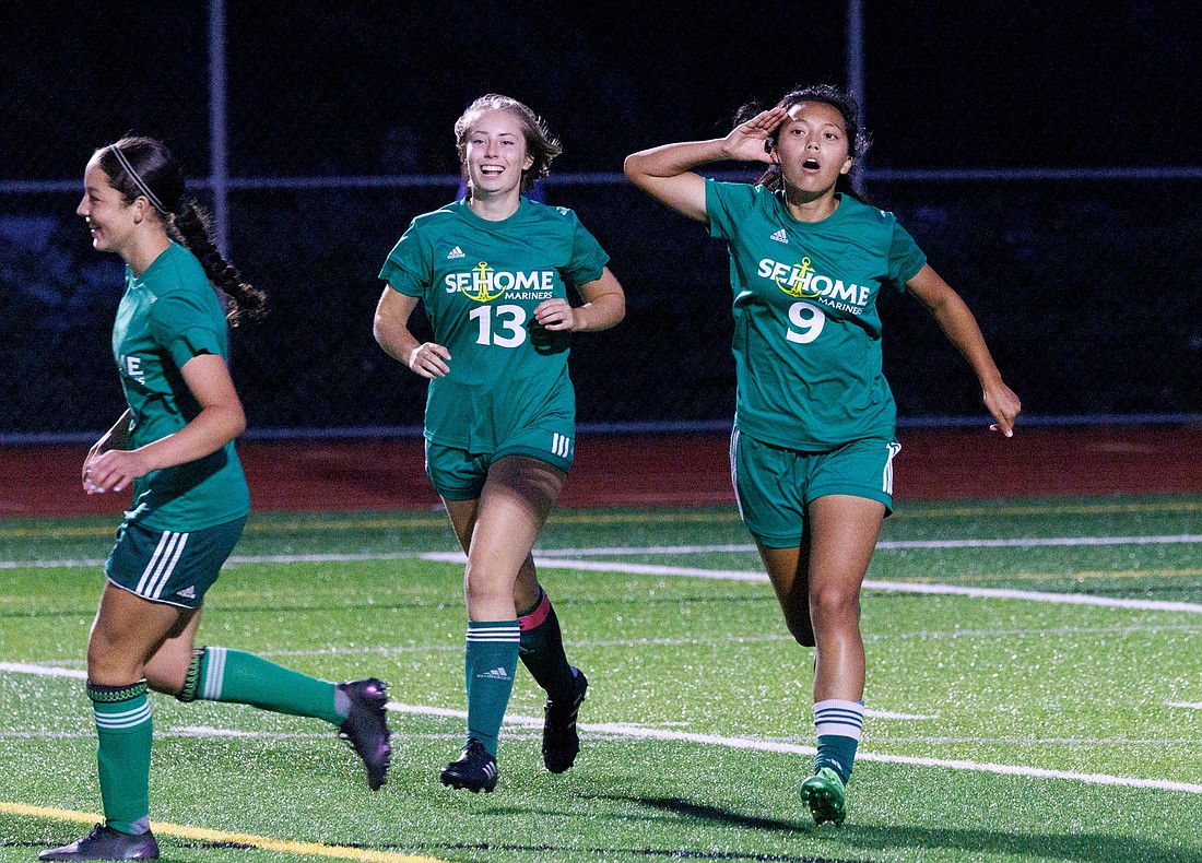 Evelyn Keay, right, holds her hand up to her ear after scoring a goal as Sehome girls soccer team beat Squalicum 3-0 on Sept. 15.