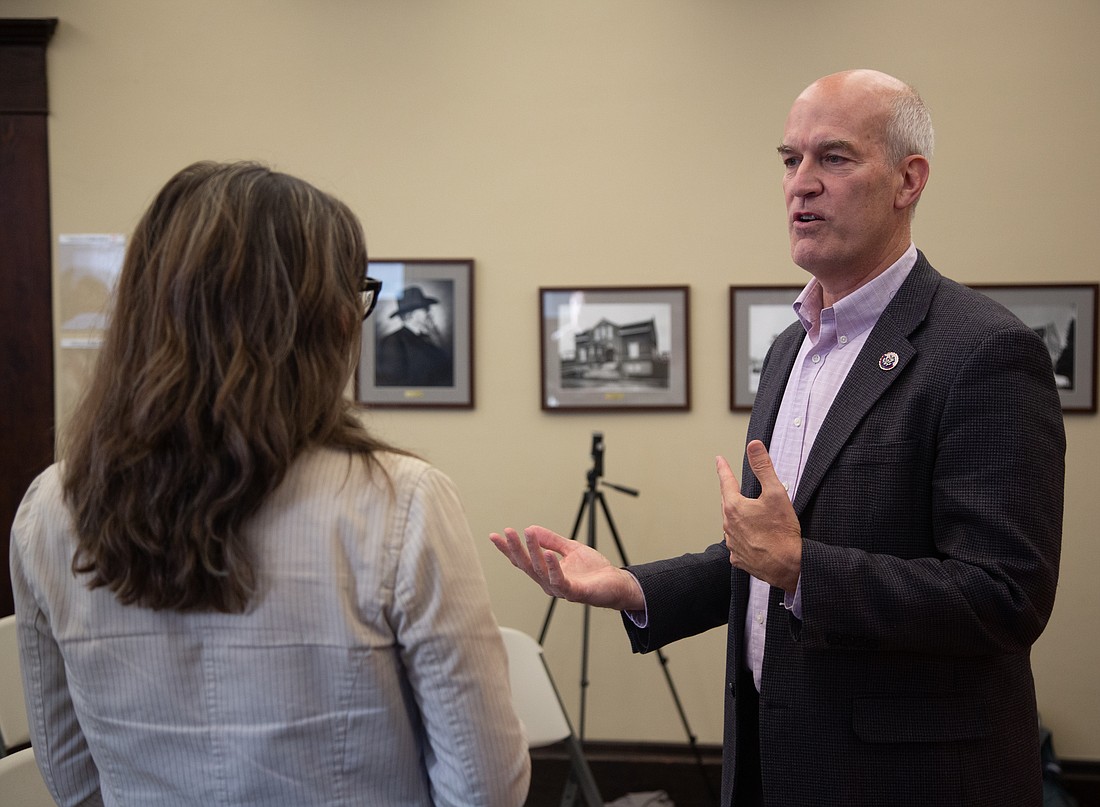 U.S. Rep. Rick Larsen speaks with an audience member following a community coffee meeting at the Fairhaven Library on Oct. 13.