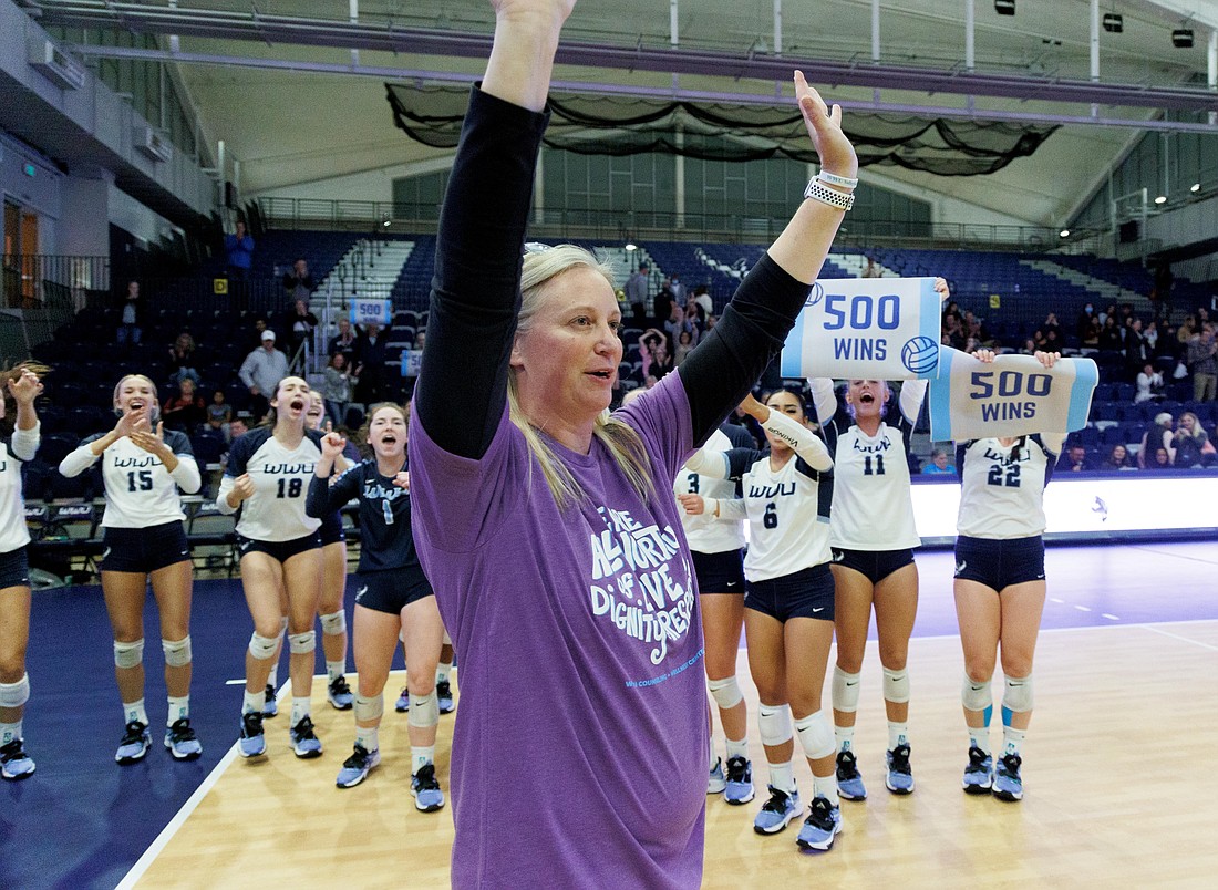 Western Washington University volleyball head coach Diane Flick-Williams waves to fans after winning her 500th game as the Vikings downed the University of Alaska-Fairbanks in three straight sets on Oct. 20.