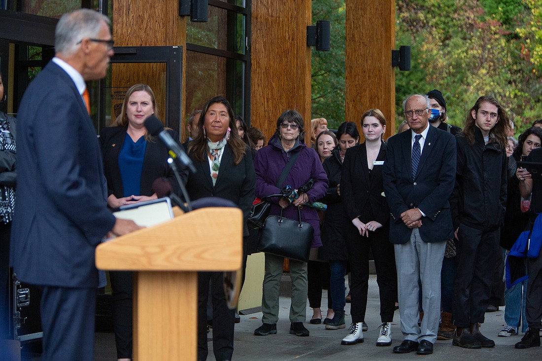 Gov. Jay Inslee, left, speaks to a crowd that includes Rep. Alicia Rule, second from left, and Rep. Debra Lekanoff, third from left, at Western Washington University on Oct. 21. Inslee announced new legislation to enhance abortion rights in the state, including a proposed constitutional amendment.