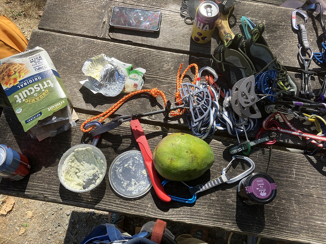 Smoky day climbing essentials: lead climbing gear, La Sportiva climbing shoes, cheese and a mango.