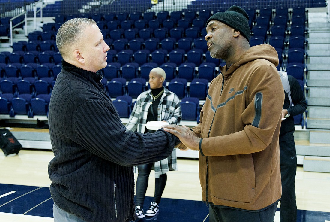 Long after the game is done and after signing autographs, Lincoln University men's basketball coach Gary Payton, a former Seattle SuperSonics player, takes time to share a personal talk with Western Washington University head coach Tony Dominquez on Oct. 26.