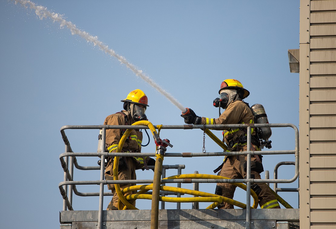 Bellingham Fire recruits practice using hoses on the third story of a building at the Bellingham Fire Academy on Oct. 6.