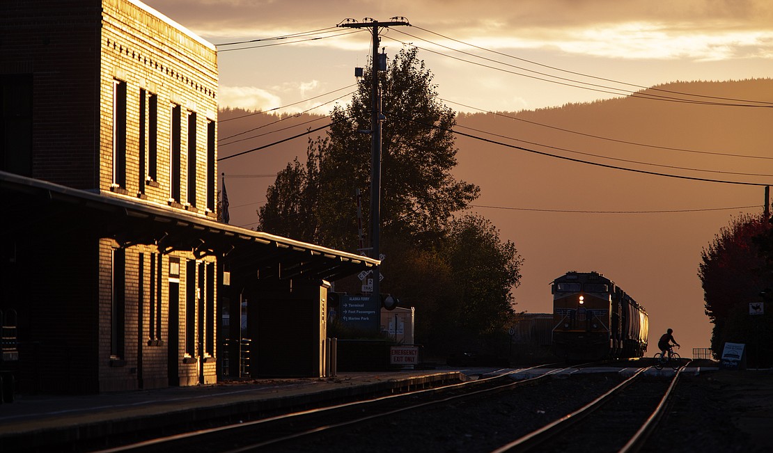 A biker crosses the railroad tracks outside the Amtrak station in Fairhaven at sunset on Oct. 25.