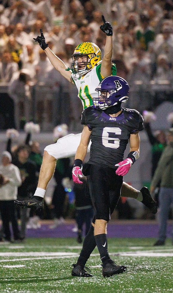 After two other attempts due to penalties, Lynden's Troy Petz leaps for joy as his third field goal attempt goes through the uprights late in the fourth quarter.