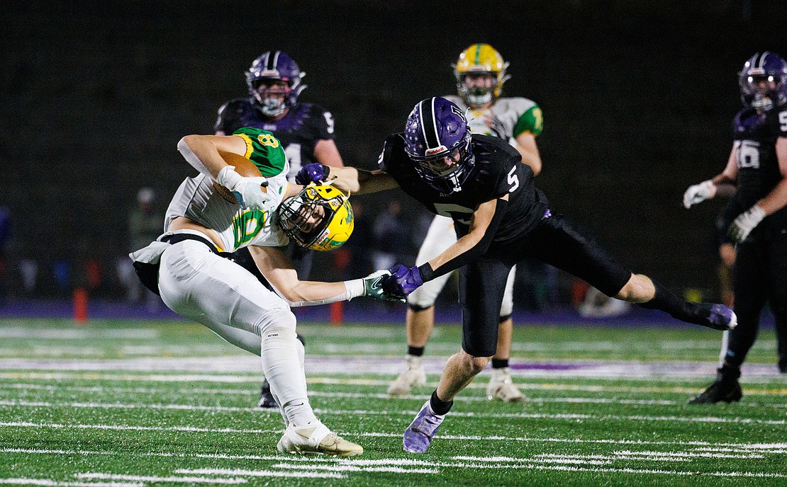 Lynden's Isaiah Stanley gets grabbed by the helmet and wrist by Anacortes sophomore Brady Beaner on Oct. 28. No penalty was called on the play.