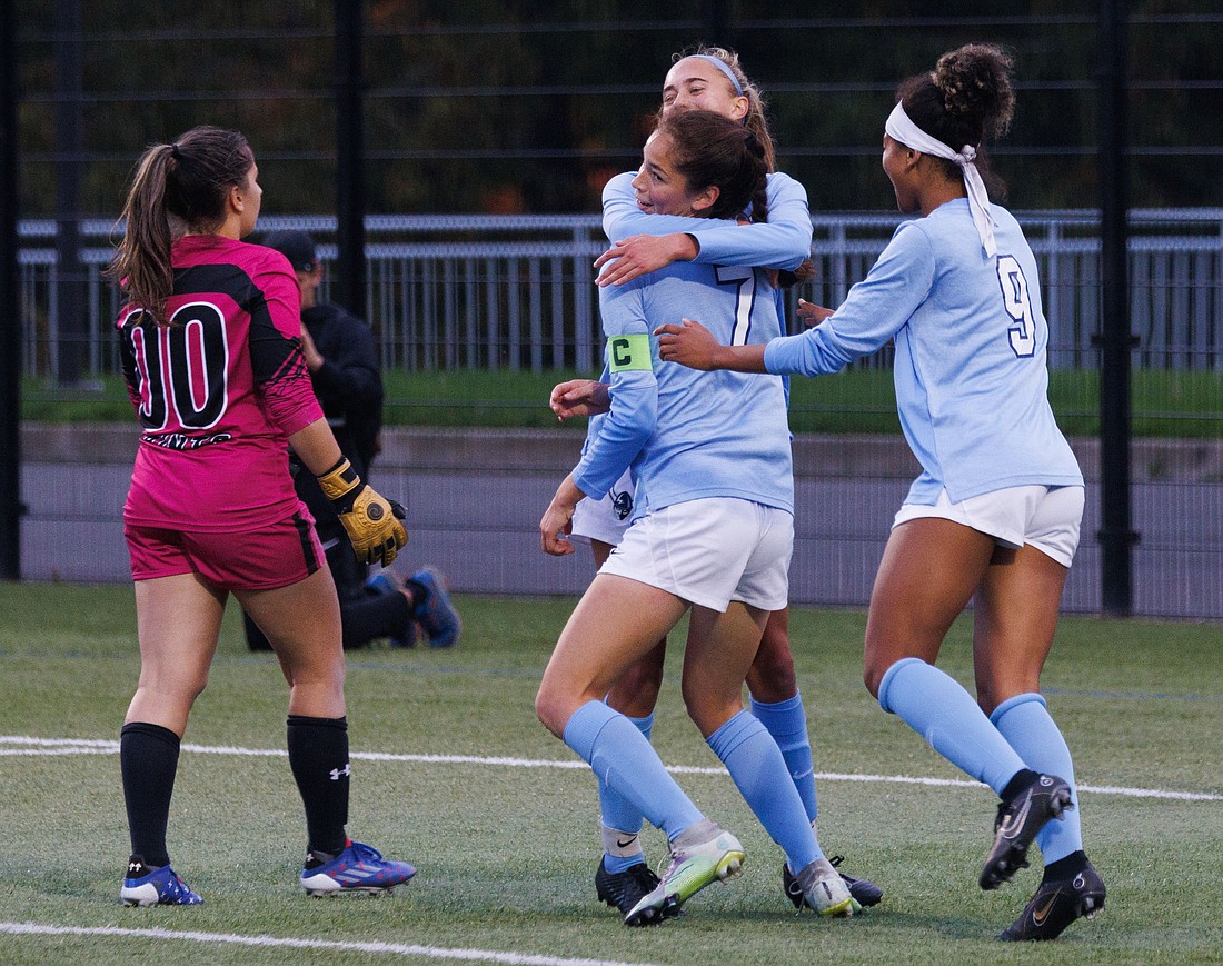 Teammates hug Dayana Diaz (7) after she scores the second goal of the game against Saint Martin's. Western Washington University won 3-0 to take the Great Northwest Athletic Conference regular season title.