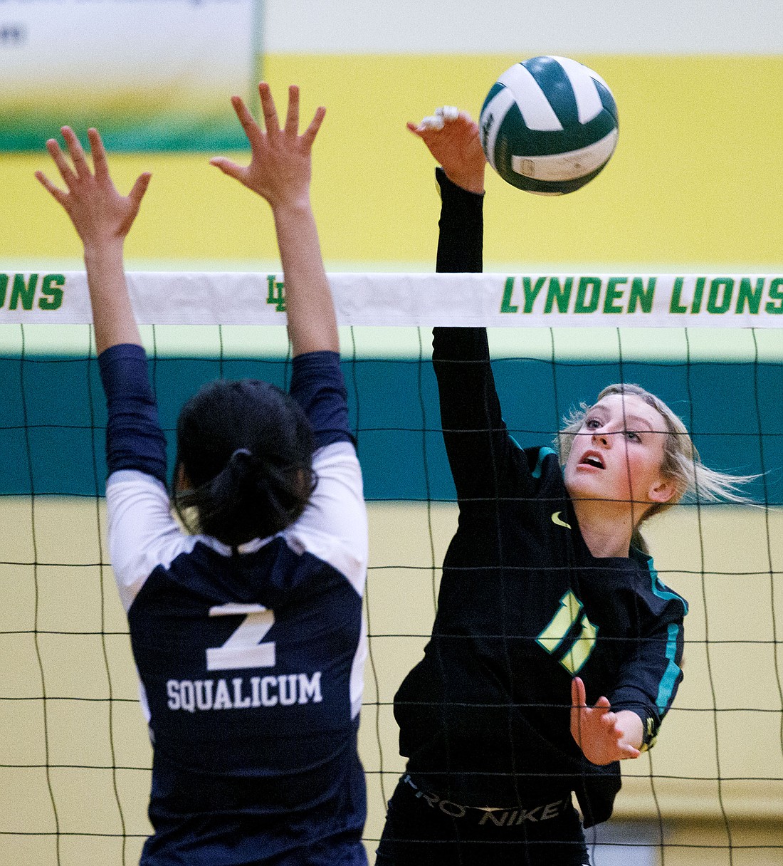 Lynden’s Rain Stephan spikes the ball past Squalicum’s Chloe Nguyen as the Lions beat Squalicum in three straight sets Monday night.