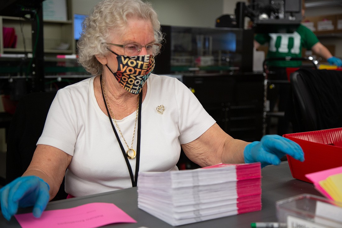 Judy Slotemaker processes ballots at the Whatcom County Auditor's Office on Oct. 31.
