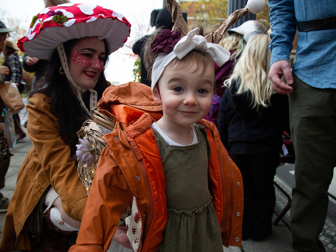 Saorise Hindman, 2, dons a snail costume, in tandem with her mom Katja dressed as a mushroom while trick-or-treating at businesses in downtown Bellingham on Oct. 31.