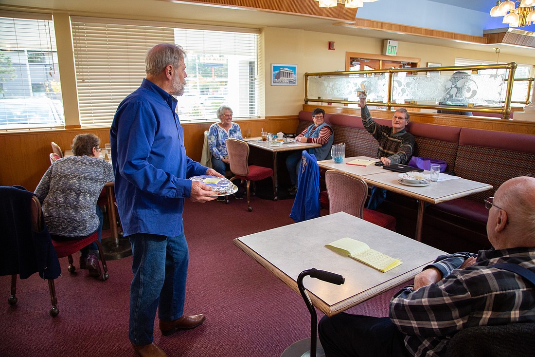 Baked goods are auctioned off at a Kiwanis Club of Bellingham meeting at the Five Columns Greek Restaurant on Nov. 1. The Key Club at Sehome High School donated the goods to raise money for families in need at their high school.