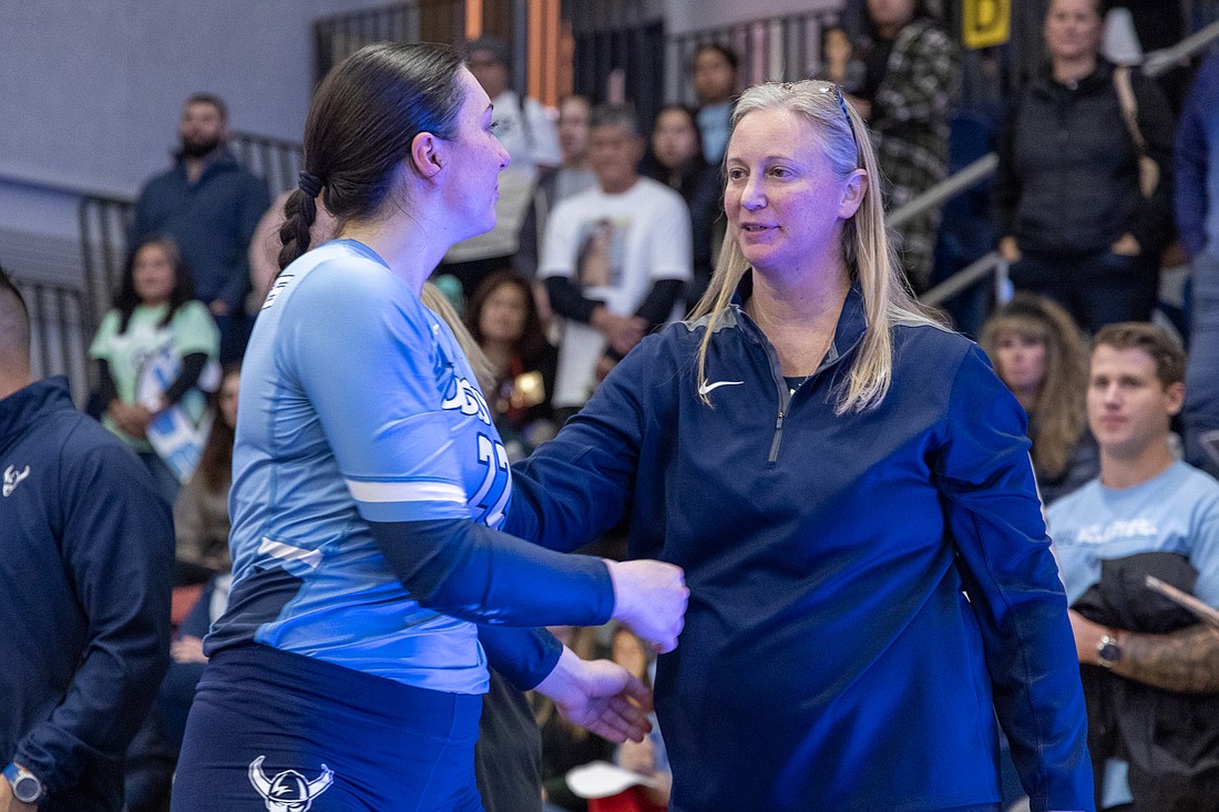 Western Washington University volleyball coach Diane Flick-Williams, right, shares a moment with senior Gabby Gunterman on senior night at Carver Gym Nov. 5.
