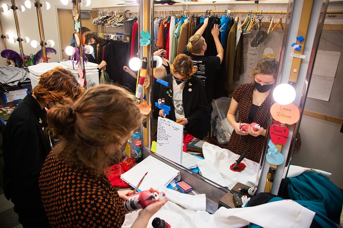 Students prepare costumes before dress rehearsal.