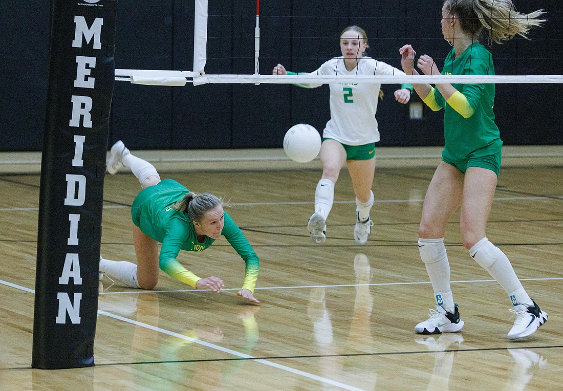 Lynden's Grace Rice dives but is unable to dig up the ball in an Oct. 12 game against Meridian.