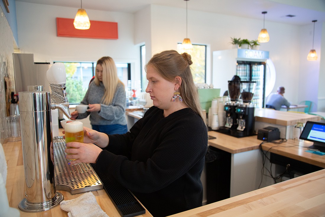 Moniece Mueller pours a beer at ROAM Coffee + Beer on Nov. 11. The new cafe, operated by the Wander Brewing team, opened Nov. 10 in the former Carne building at the convergence of three Bellingham neighborhoods — Columbia, Lettered Streets and the Fountain District.