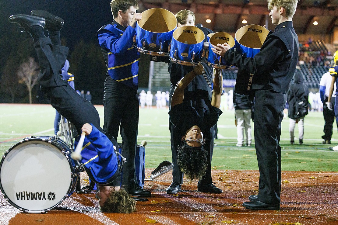Pablo Mendoza plays the drums held upside-down by band members while Kayt Woodward plays bass in similar fashion during halftime of the Ferndale versus Seattle Prep football game Nov. 4.