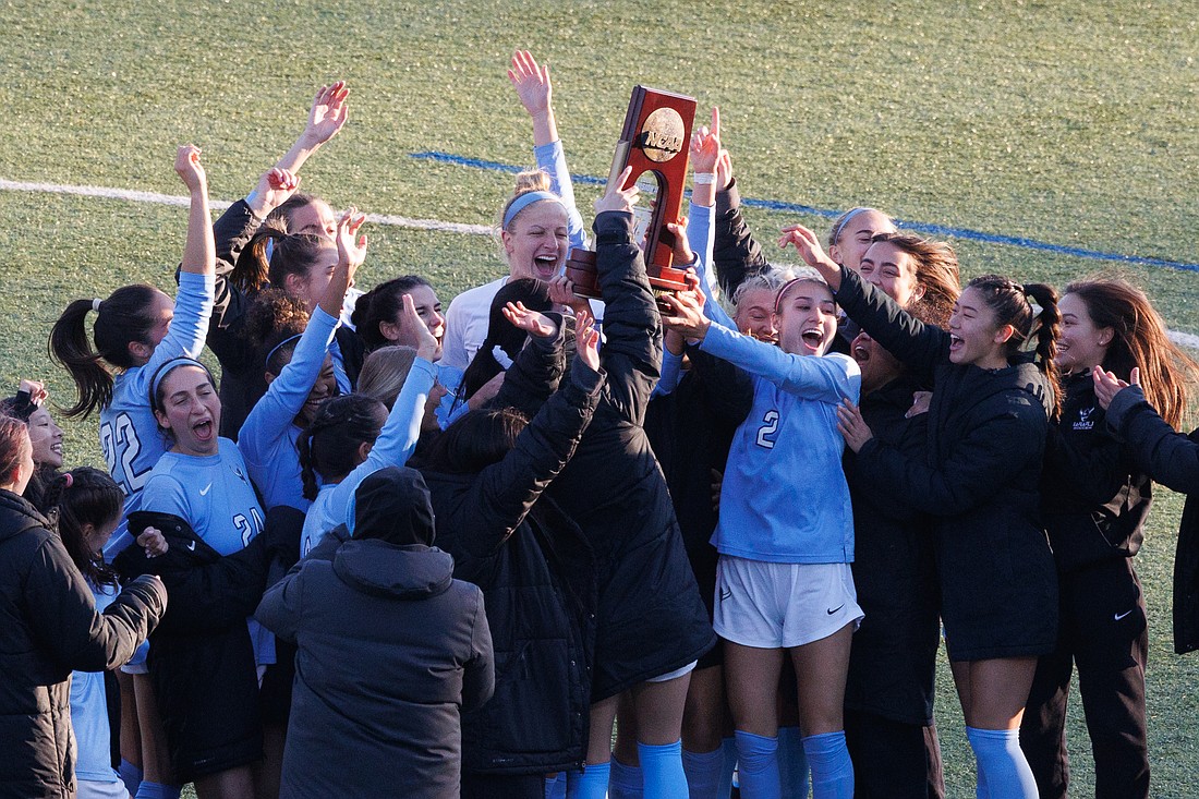 The Western Washington University women's soccer team celebrates with a trophy after beating Concordia University Irvine 1-0 in the West Regional Final on Nov. 17.
