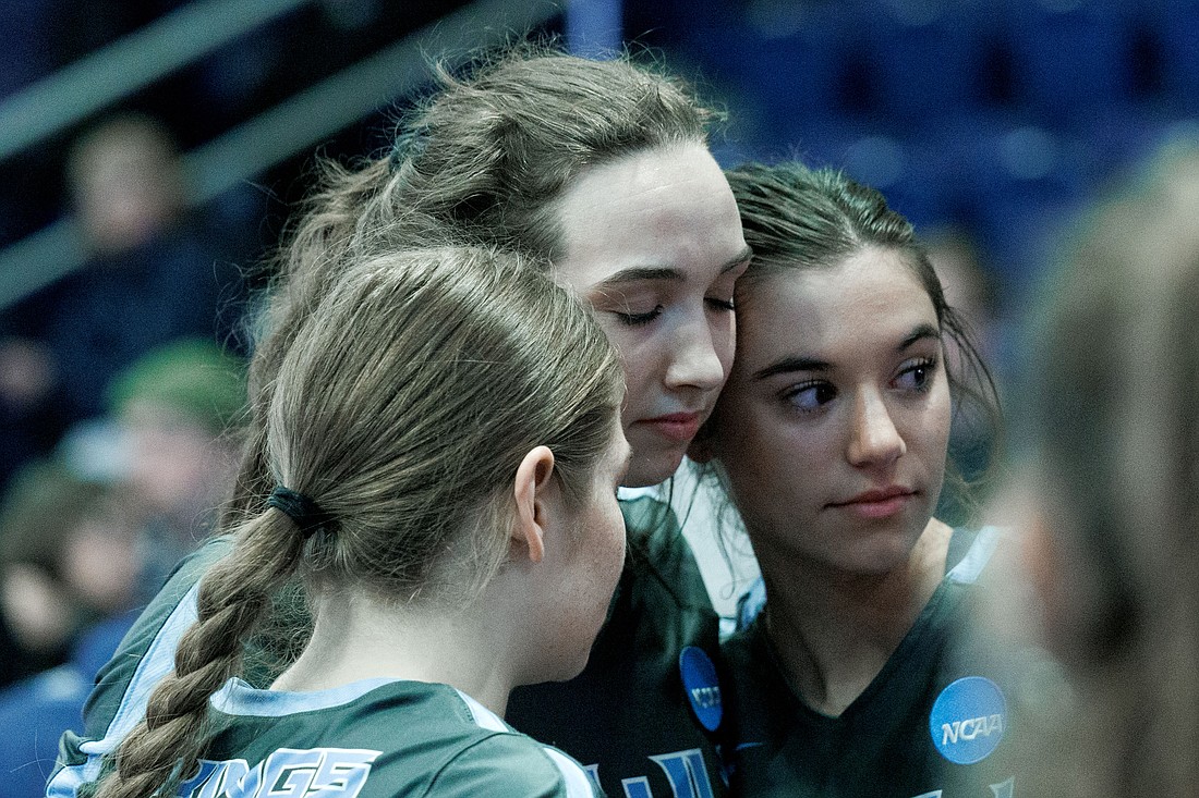 Western Washington University's Calley Heilborn, center, is hugged by teammates after the Vikings were upset by Central Washington University 3-1 in the first round of the NCAA DII West Regional volleyball tournament on Nov. 17.