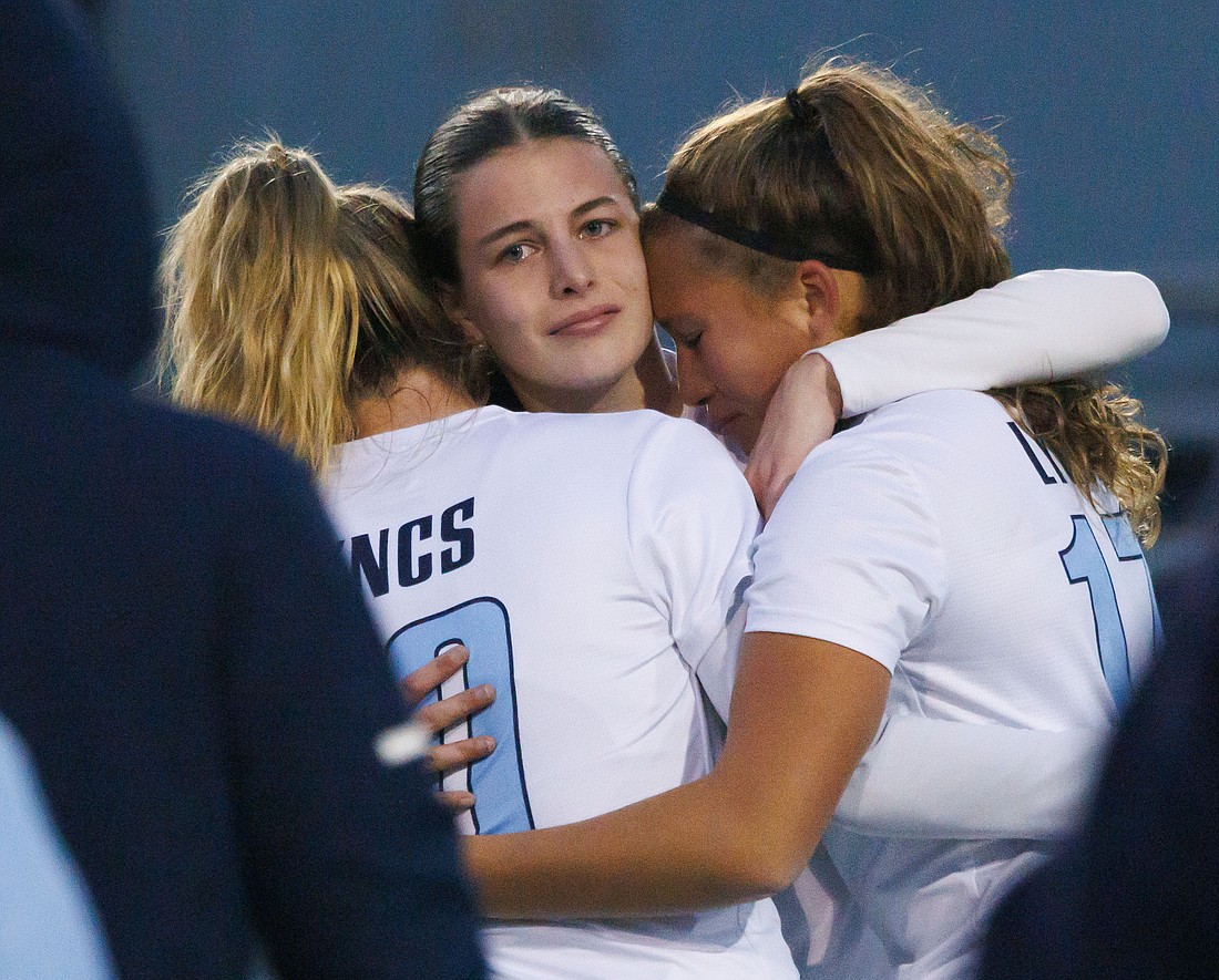 Lynden Christian's Alexie Hagen, Daisy Poag and Ellie VanLoo, right, hug after the Lyncs lost 3-1 to Klahowya in the 1A girls soccer state championship game at Shoreline Stadium on Nov. 19.