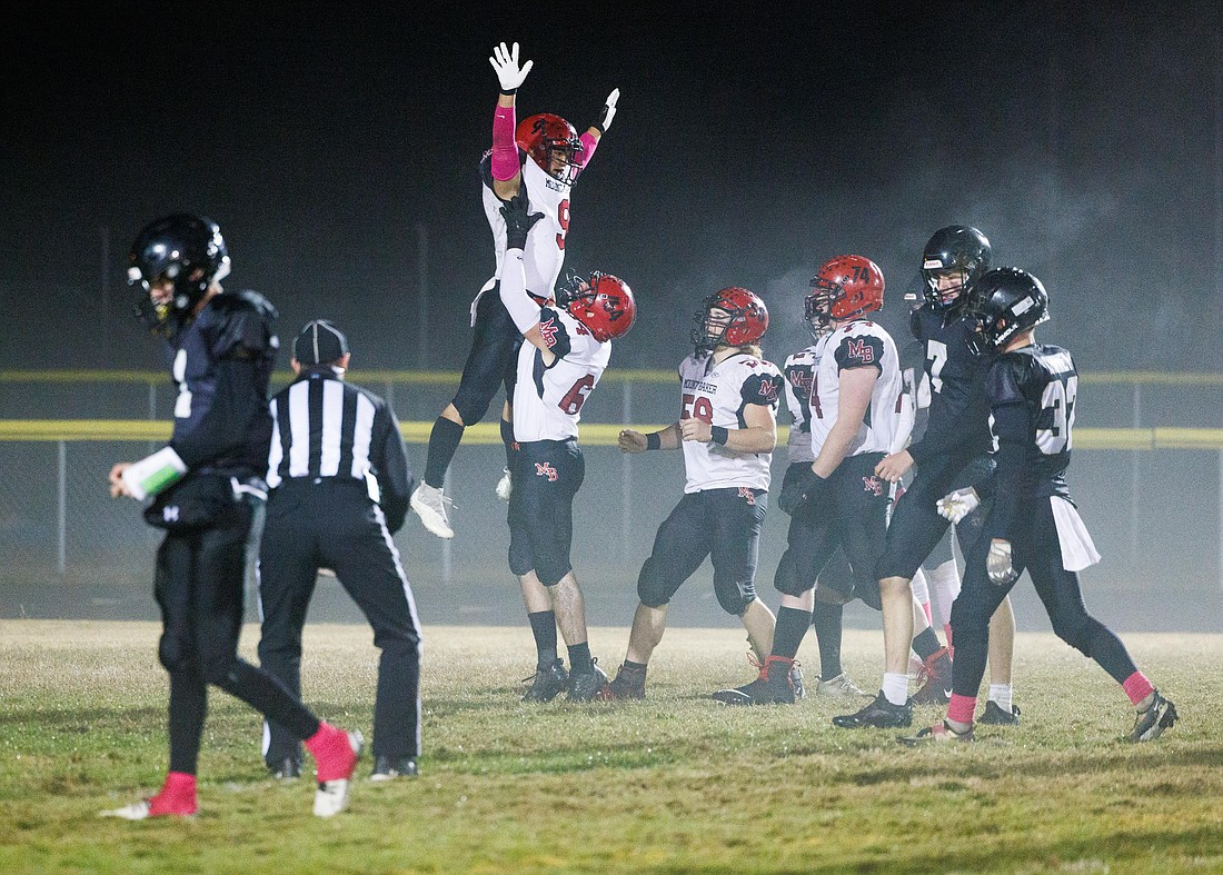 Mount Baker's Marcques George is hoisted into the air by teammate Alex Maloley after scoring a touchdown in a game versus Meridian on Oct. 21.
