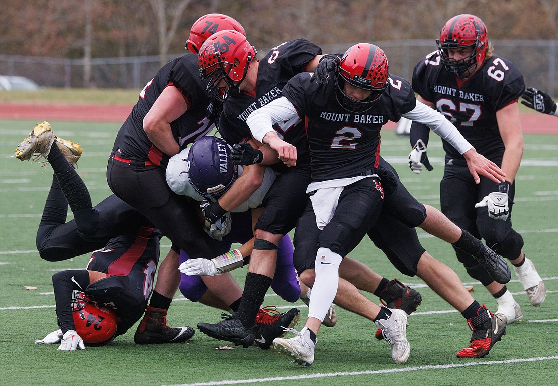Nooksack Valley’s Colton Lentz is tackled by a swarm of Mount Baker defenders.