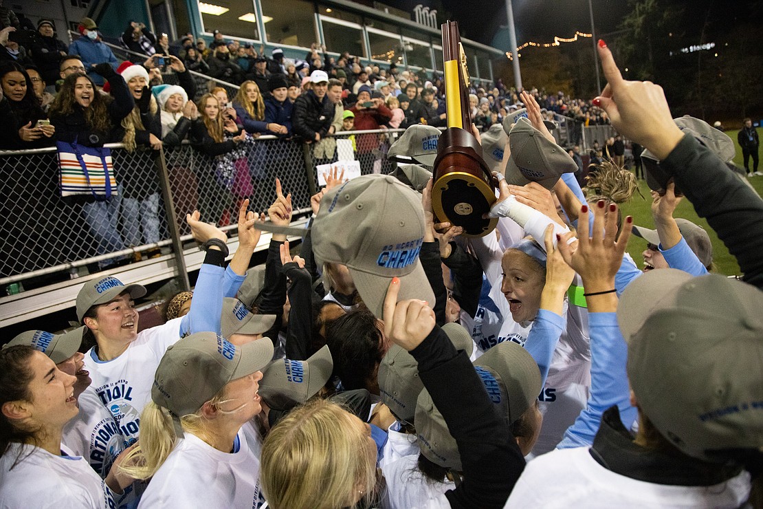 The Western Washington University women's soccer team celebrates with the Division II national championship trophy after beating top-seeded West Chester 2-1 at Seattle's Interbay Stadium on Dec. 3.