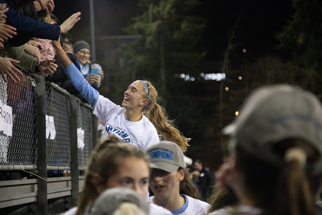 Claire Potter high-fives fans after the match.