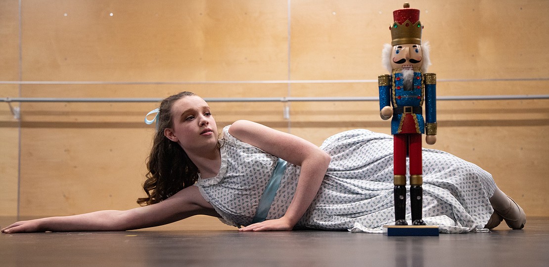 Charlotte Miller as Clara awakens at the end of the ballet to find a wooden nutcracker by her side at a rehearsal of "The Nutcracker."